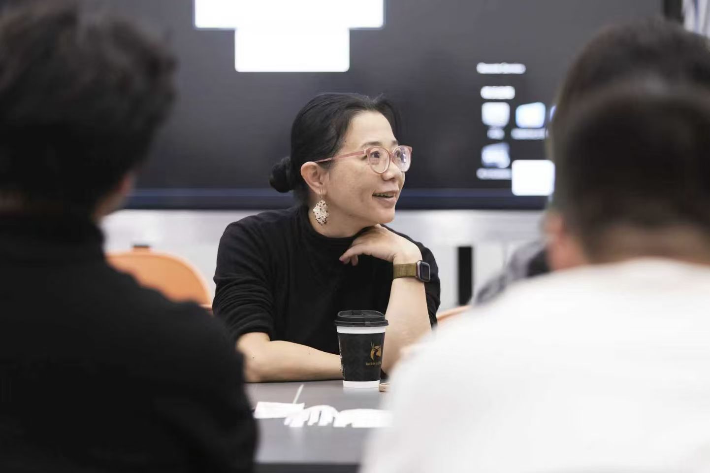Fan Xiang in conversation with participants during a working session