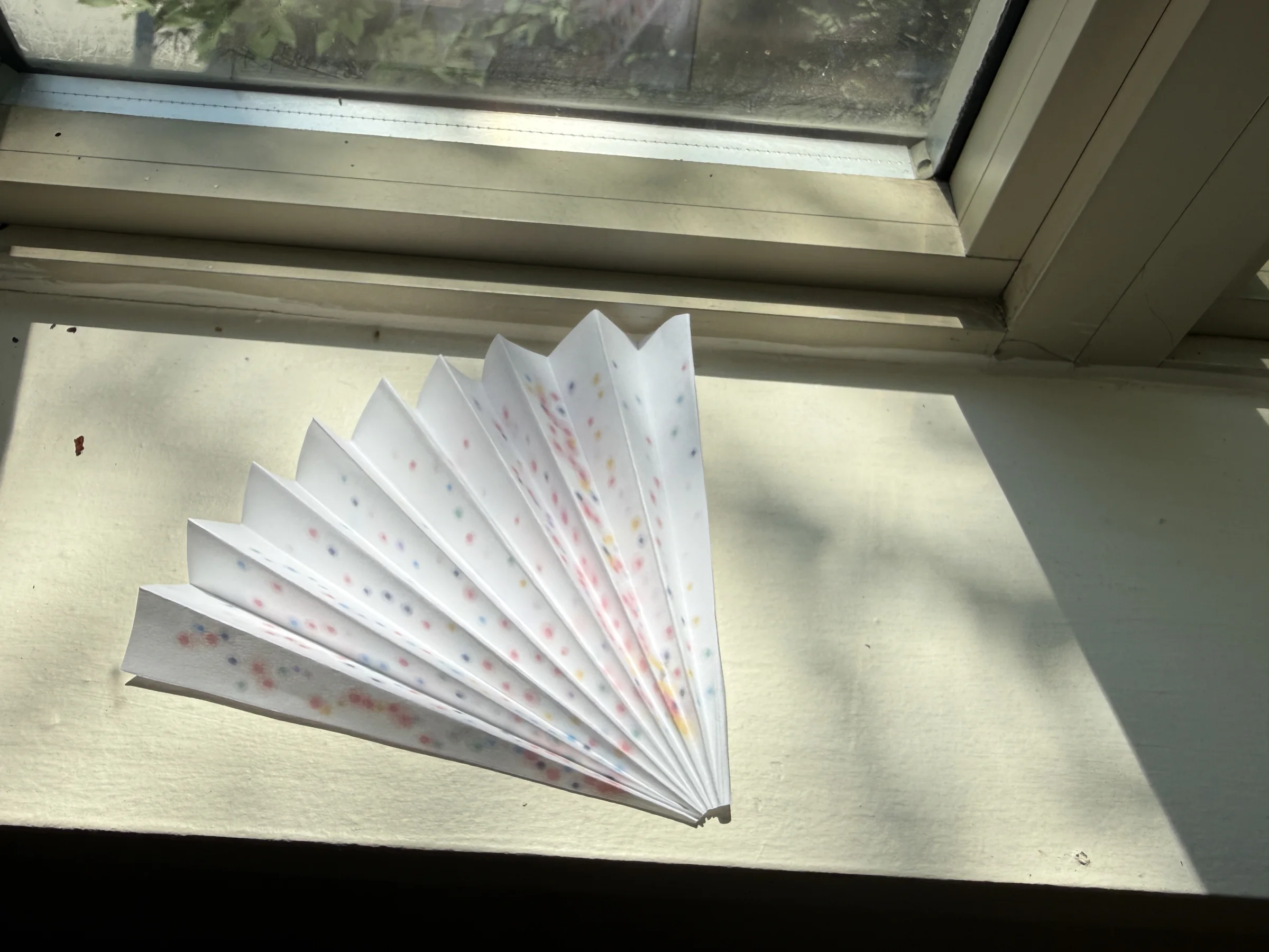 Eighteen Springs paper fan viewed in daylight